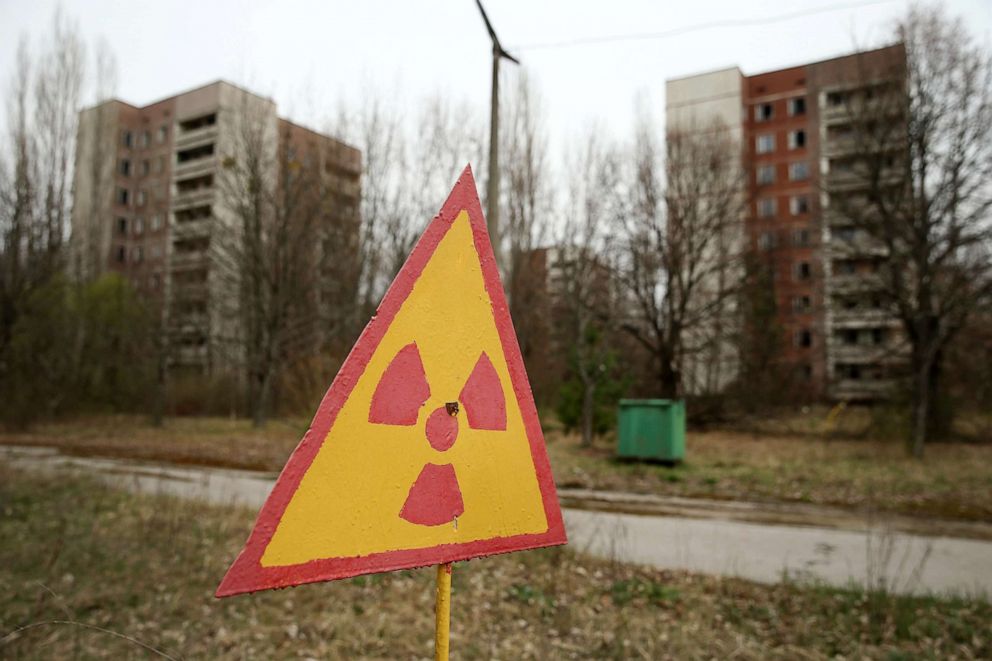 PHOTO: A sign warns of radiation contamination near former apartment buildings in Pripyat, Ukraine, April 9, 2016.