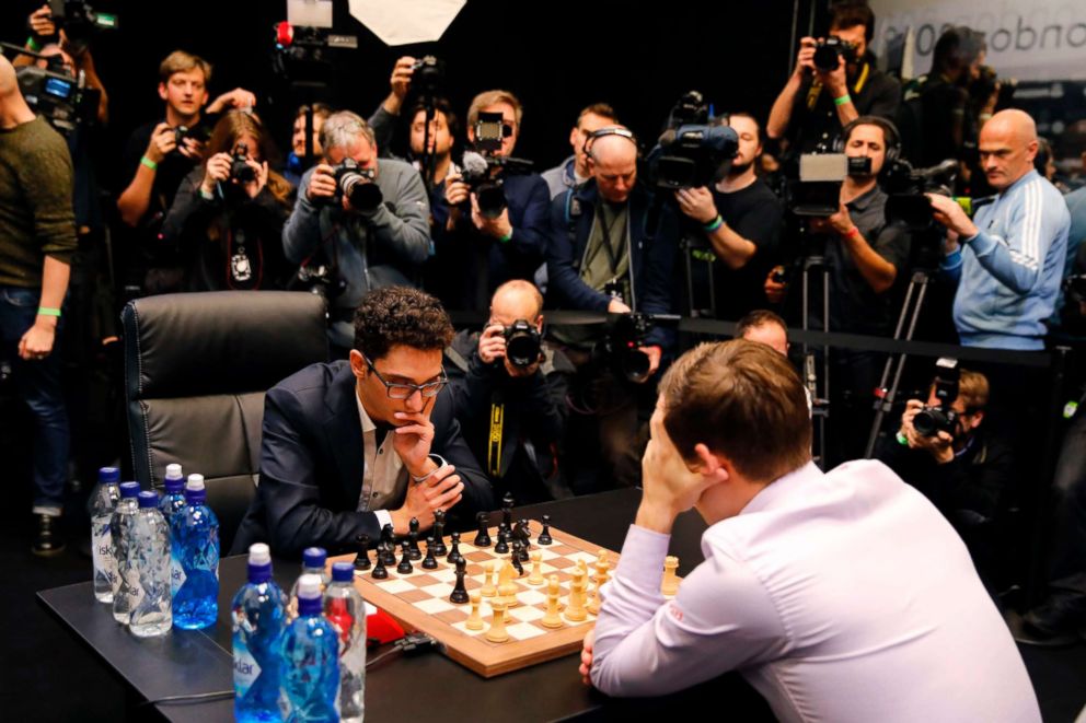 PHOTO: Cameras are trained on reigning world chess champion, Norway's Magnus Carlsen and challenger, Fabiano Caruana from the U.S., as they play the first game of the tie-break matches of the 2018 World Chess Championship in London on Nov. 28, 2018.
