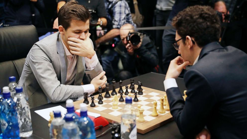 PHOTO: Reigning chess world champion Magnus Carlsen, left, from Norway, plays Italian-American challenger Fabiano Caruana in the first few minutes of round 12 of their World Chess Championship Match in London, Nov. 26, 2018.