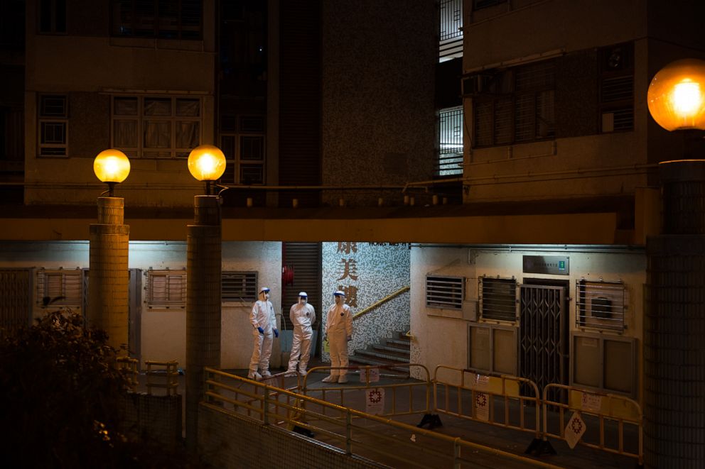 PHOTO: Officials wearing protective gear stand guard outside an entrance to the Hong Mei House residential building at Cheung Hong Estate in the Tsing Yi district, Hong Kong, China, on Feb. 11, 2020.