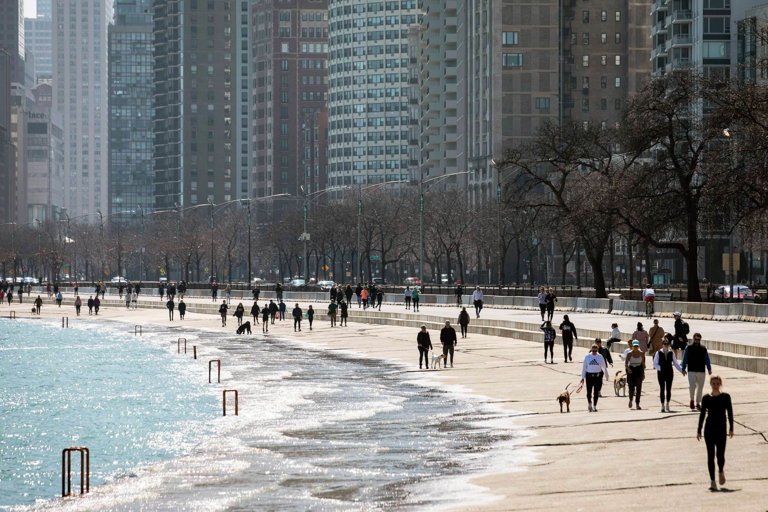 PHOTO: Residents enjoy the warm weather with a stroll along the Lakefront Trail near Oak Street Beach, March 25, 2020, in Chicago, despite a stay-at-home order from Illinois Gov. J.B. Pritzker during the coronavirus pandemic.