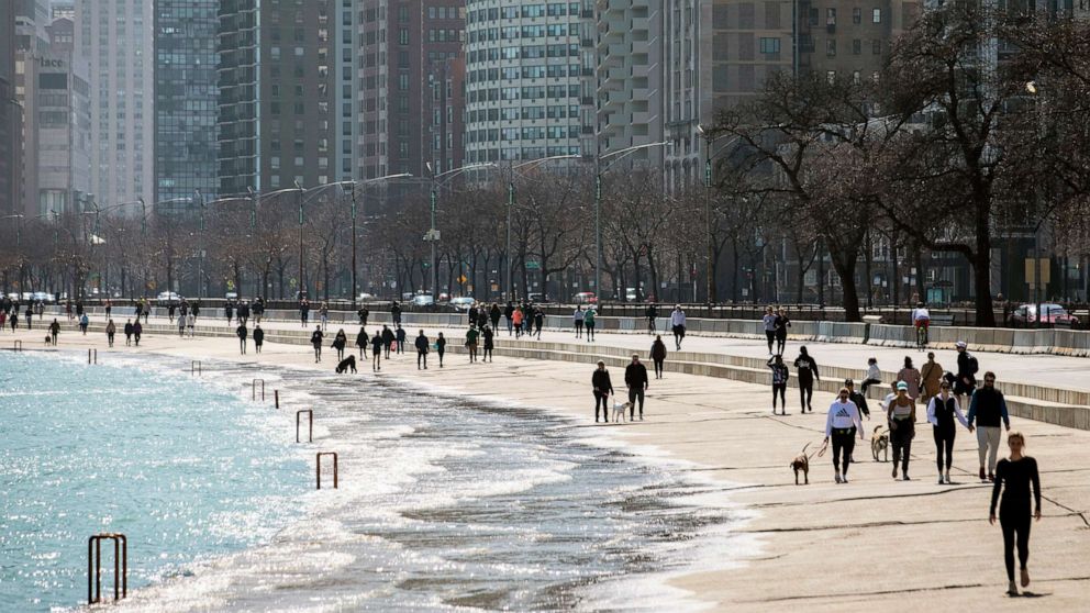 PHOTO: Residents enjoy the warm weather with a stroll along the Lakefront Trail near Oak Street Beach, March 25, 2020, in Chicago, despite a stay-at-home order from Illinois Gov. J.B. Pritzker during the coronavirus pandemic.