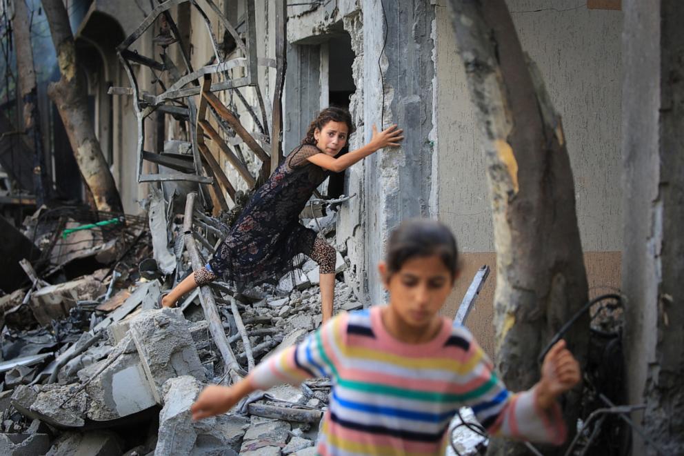 PHOTO: A Palestinian girl climbs over debris a day after an operation by the Israeli Special Forces in the Nuseirat camp, in the central Gaza Strip on June 9, 2024, amid the ongoing conflict between Israel and the Palestinian Hamas militant group.