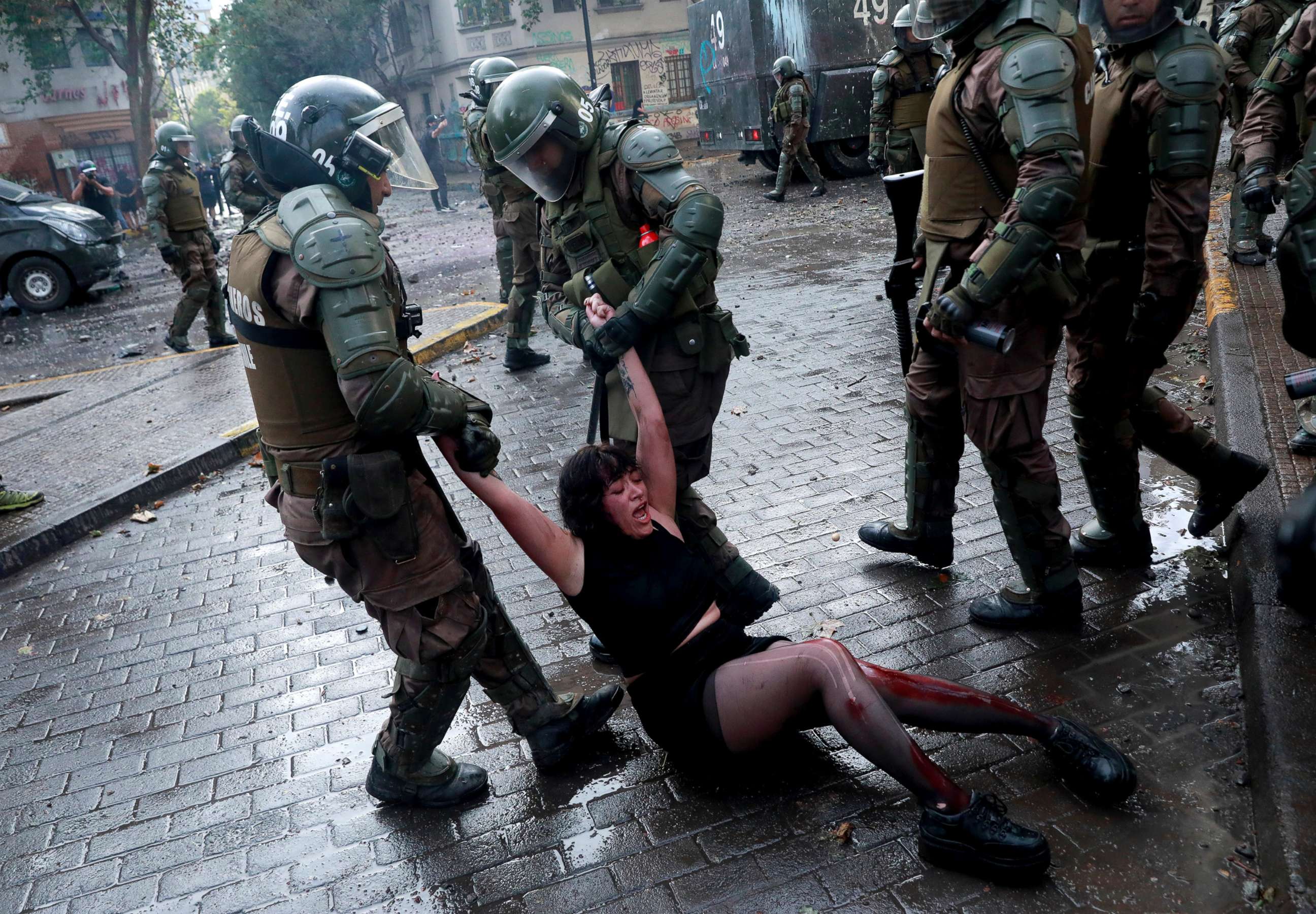 PHOTO: Riot police officers detain Camila Miranda after she was shot with 6 rubber bullets, 4 of which pierced her skin during a protest which she was demonstrating at against Chile's government in Santiago, Chile, Nov. 4, 2019. 