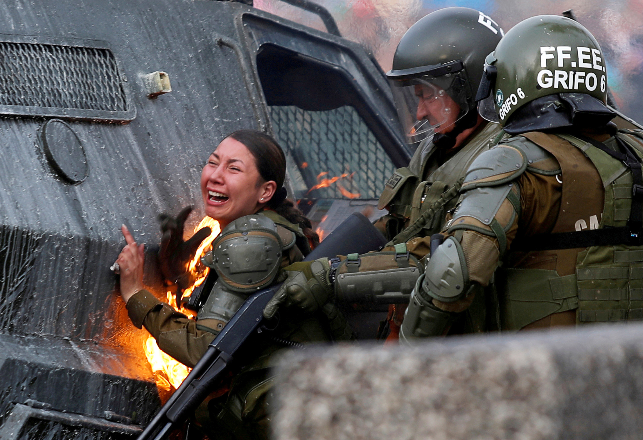 PHOTO: A riot police officer on fire reacts during a protest against Chile's government in Santiago, Chile, Nov. 4, 2019.