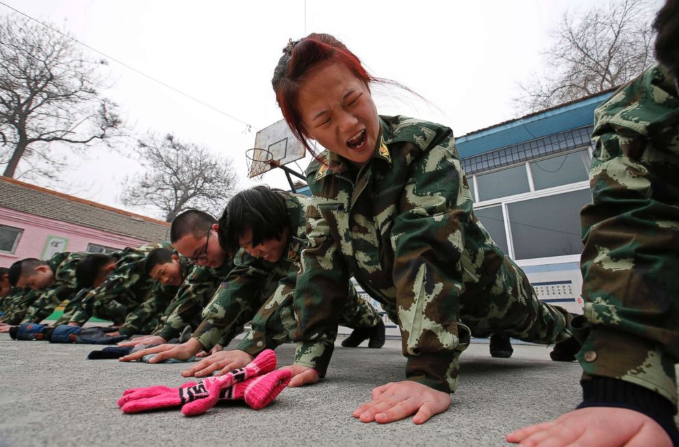 PHOTO: Students receive a group punishment during a military-style close-order drill class at the Qide Education Center in Beijing in this Feb. 19, 2014 file photo.