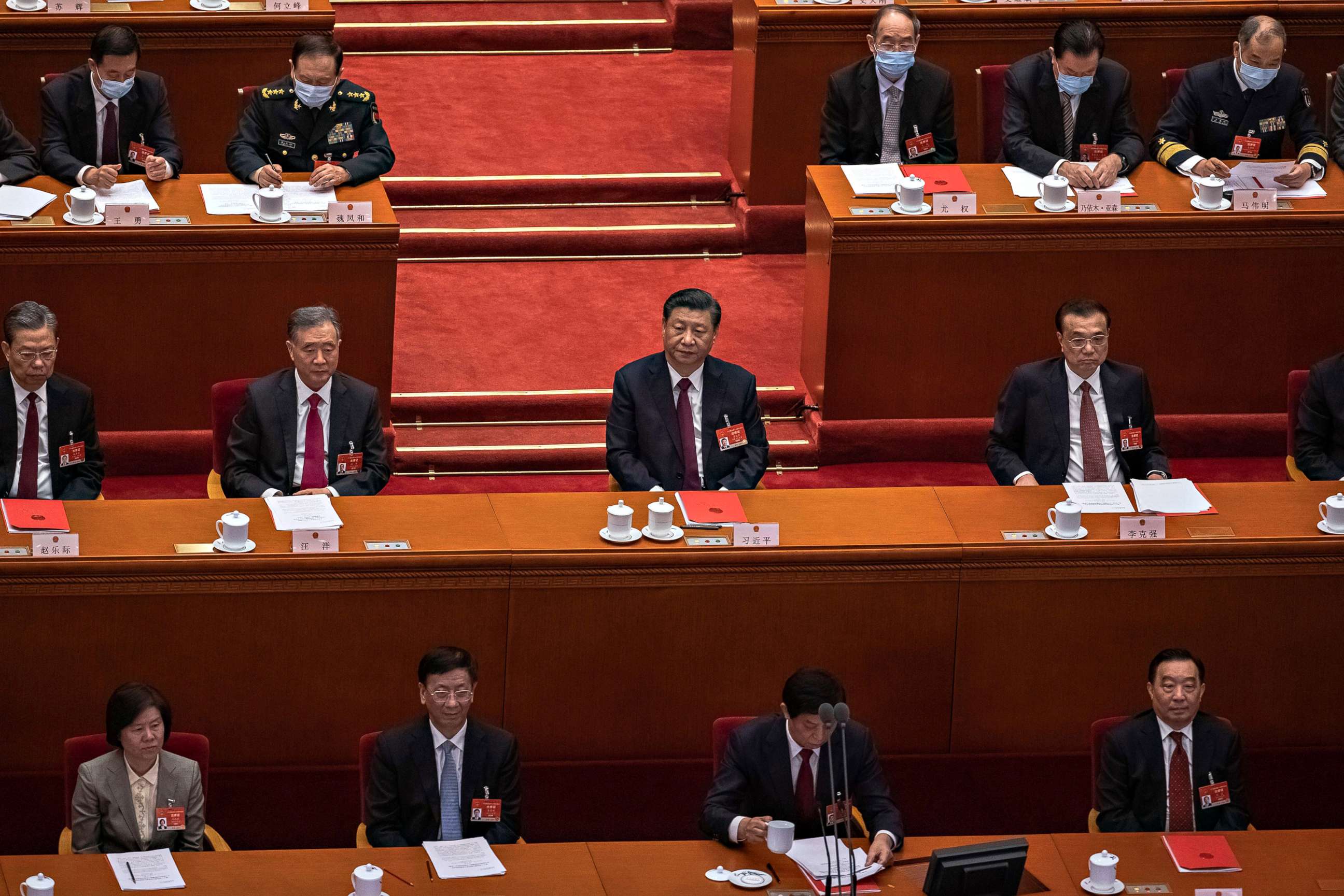 PHOTO: Chinese President Xi Jinping, center, and Premier Li Keqiang, right, sit with other delegates during the closing session of the National People's Congress (NPC), at the Great Hall of the People, in Beijing on  March 11, 2021.