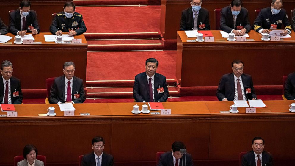 PHOTO: Chinese President Xi Jinping, center, and Premier Li Keqiang, right, sit with other delegates during the closing session of the National People's Congress (NPC), at the Great Hall of the People, in Beijing on  March 11, 2021.
