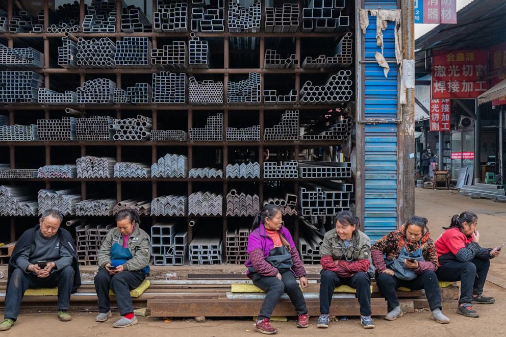 PHOTO: Workers sit in front of steel products at a steel market in southwestern China's Chongqing municipality on March 2, 2025.
