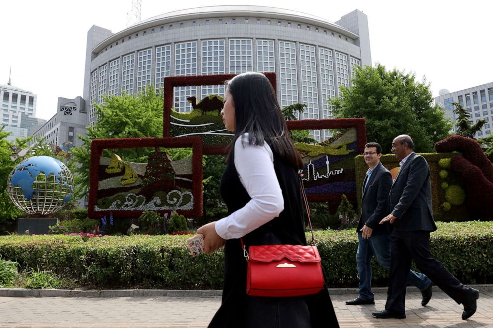 PHOTO: In this file photo taken on April 19, 2019, foreigners pass by the Chinese foreign ministry in Beijing, China.