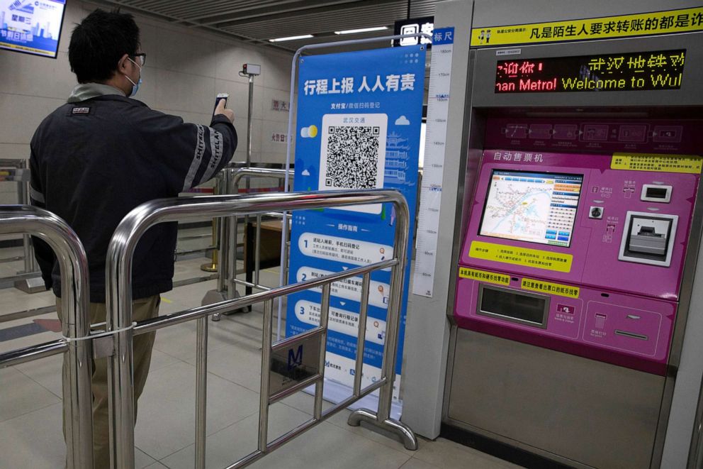 PHOTO: In this April 1, 2020, file photo, a passenger scans a QR code to get his green pass at a subway station in Wuhan in central China's Hubei province.