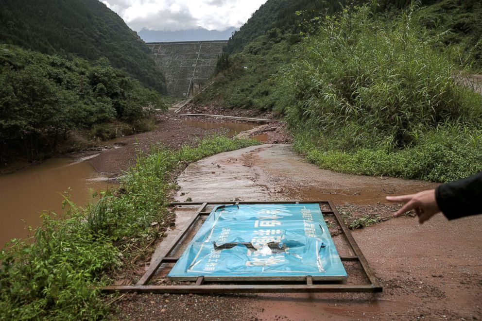 PHOTO: A sign for a fish breeding base run by a local poverty relief and migration work bureau is seen under one of the dams on the Zhougong River near Ya'an in Sichuan province, China, Aug. 4, 2018.
