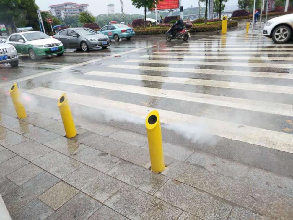 Jaywalkers risk being sprayed with water if they try to cross too soon in Hubei province in central China.
