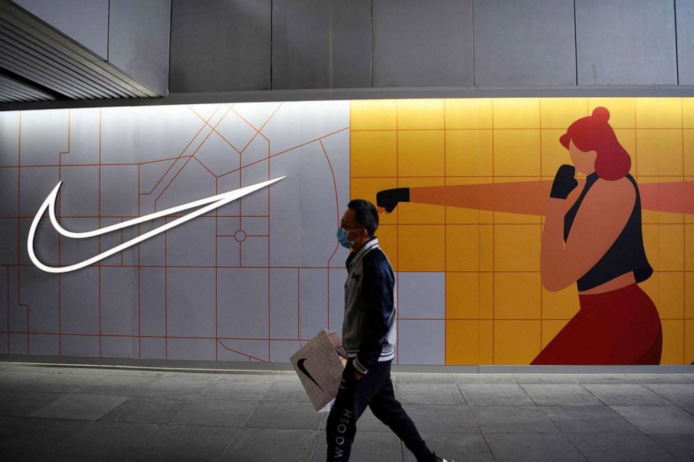 PHOTO: A man walks past a Nike store in Beijing on March 25, 2021.
