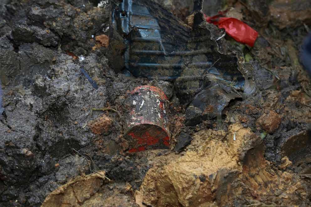PHOTO: An orange-colored 'black box' recorder is seen in on the mud at the China Eastern flight crash site in Tengxian County in southern China's Guangxi Zhuang Autonomous Region, March 23, 2022.