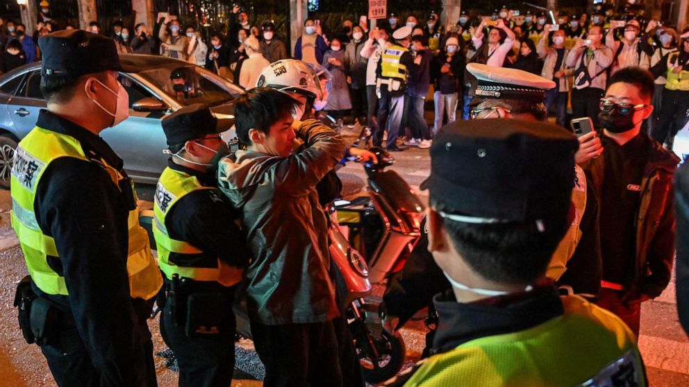 PHOTO: Police officers confront a man as they block Wulumuqi Street, Nov. 27, 2022, in Shanghai.