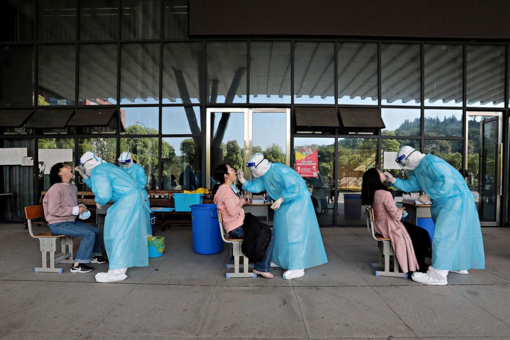 PHOTO: Hospital medical workers collect swabs from high school teachers for COVID-19 testing at a school, in Yichang, China, April 27, 2020.