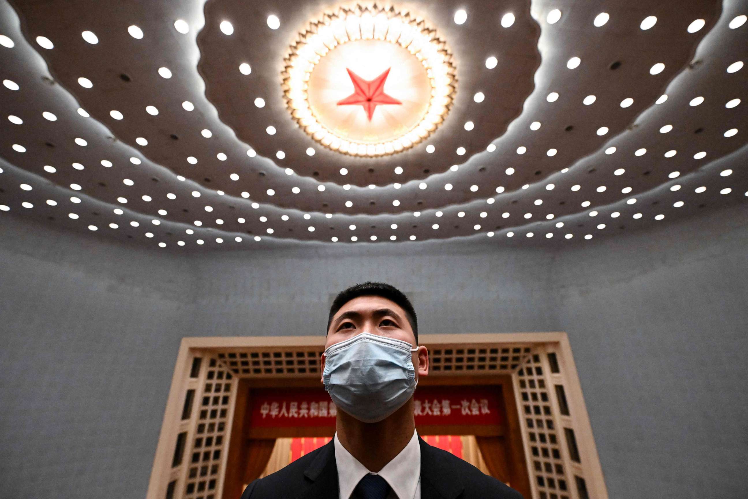PHOTO: A security officer stands guard after the opening session of the National People's Congress at the Great Hall of the People in Beijing on March 5, 2023.