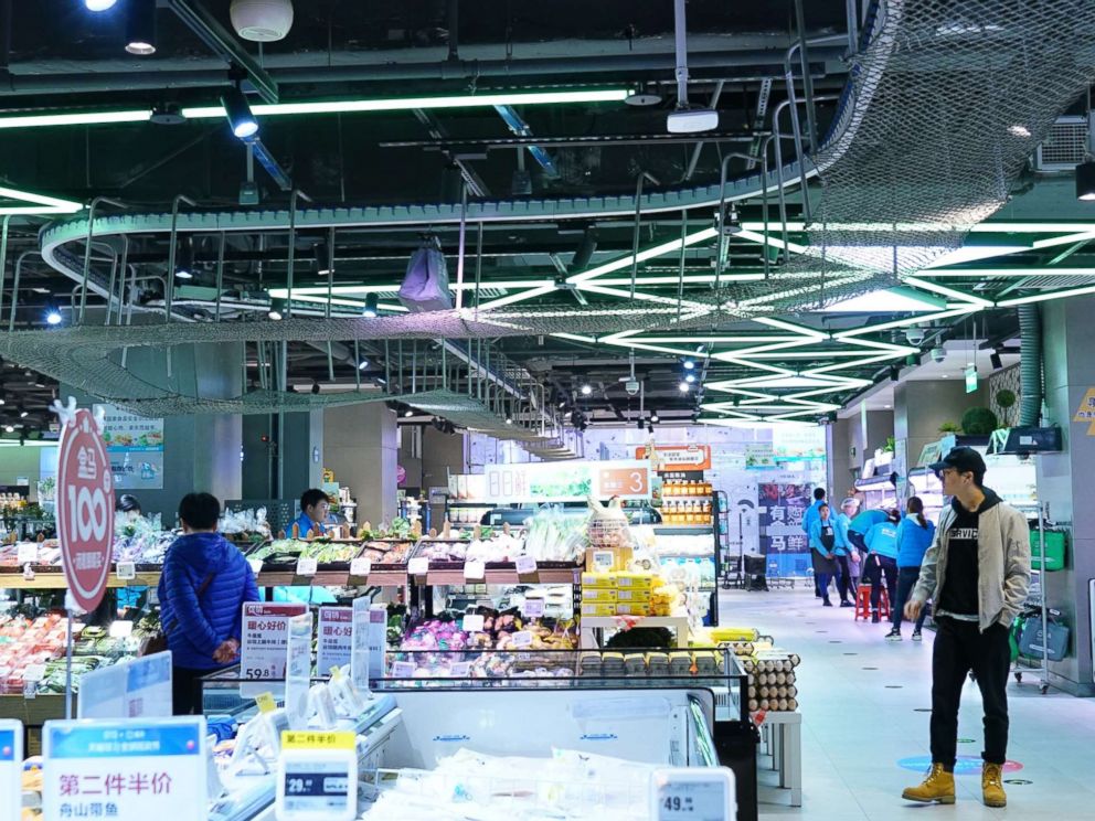 PHOTO: A conveyor belt carries a shopping bag filled with an online order across the ceiling at a store in Beijing, Nov. 7, 2018.