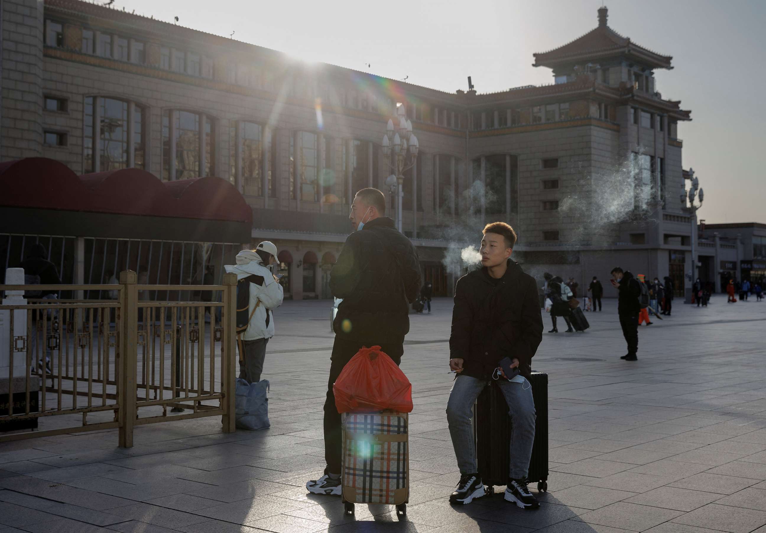 PHOTO: People wait outside Beijing Railway Station as they travel for Spring Festival ahead of Chinese Lunar New Year festivities in Beijing, China, on Jan. 16, 2023.