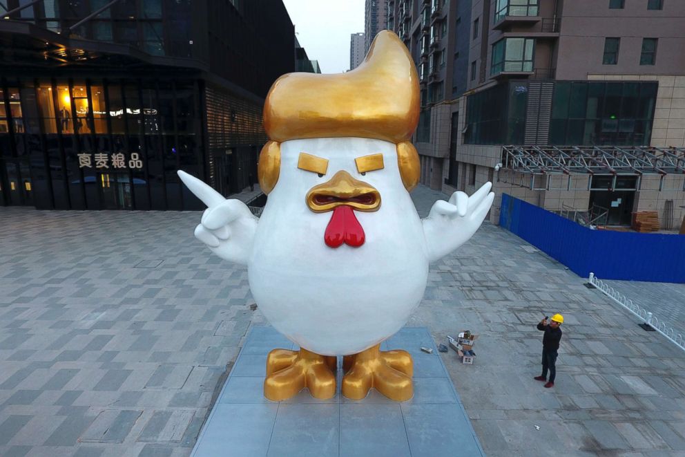 PHOTO: A worker takes a picture of a giant rooster sculpture resembling U.S. President-elect Donald Trump on display outside a shopping mall to celebrate the upcoming Chinese Year of the Rooster, Dec. 29, 2016, in Taiyuan in north China's Shanxi province.