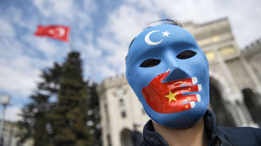 PHOTO: A demonstrator wearing a mask painted with the colours of the flag of East Turkestan takes part in a protest by supporters of the Uighur minority in Istanbul, April 1, 2021.