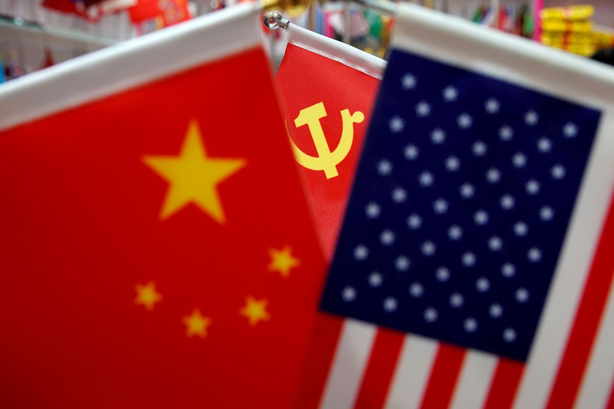 PHOTO: The flags of China, the United States and Chinese Communist Party are displayed in a flag stall at the Yiwu Wholesale Market in Yiwu, Zhejiang province, China, May 10, 2019.