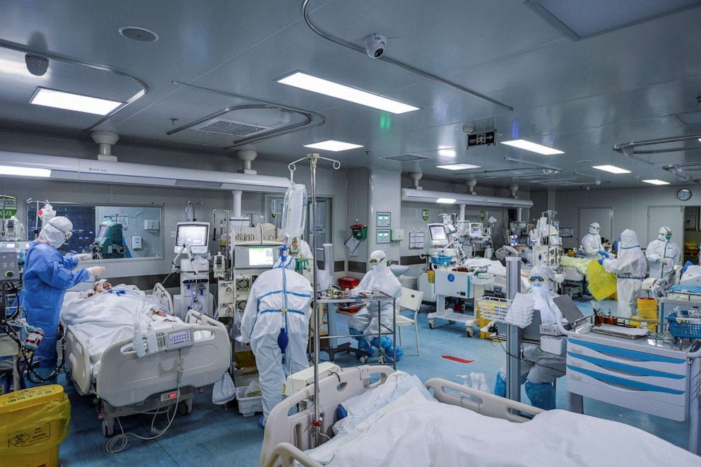 This photo taken on Feb. 24, 2020, shows medical staff treating patients infected by the novel coronavirus at a hospital in Wuhan in China's central Hubei province. The newly discovered virus has peaked in China but could still grow into a pandemic, the World Health Organization warned, as infections mushroom in other countries.Str/AFP via Getty Images