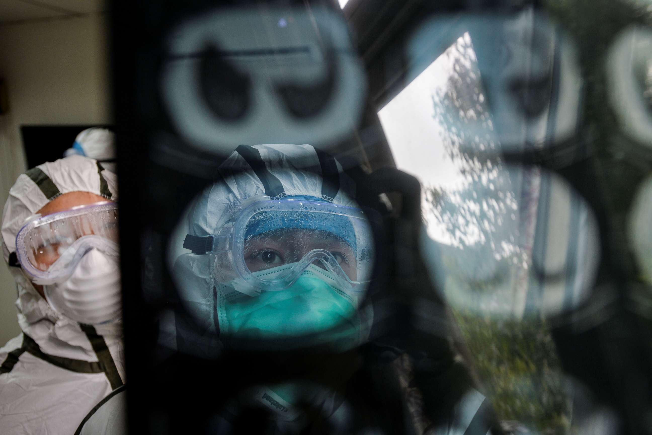 PHOTO: Medical workers in protective suits check a CT (computed tomography) scan image of a patient at a community health service center in the Qingshan district of Wuhan, Hubei province, China, Feb. 8, 2020.