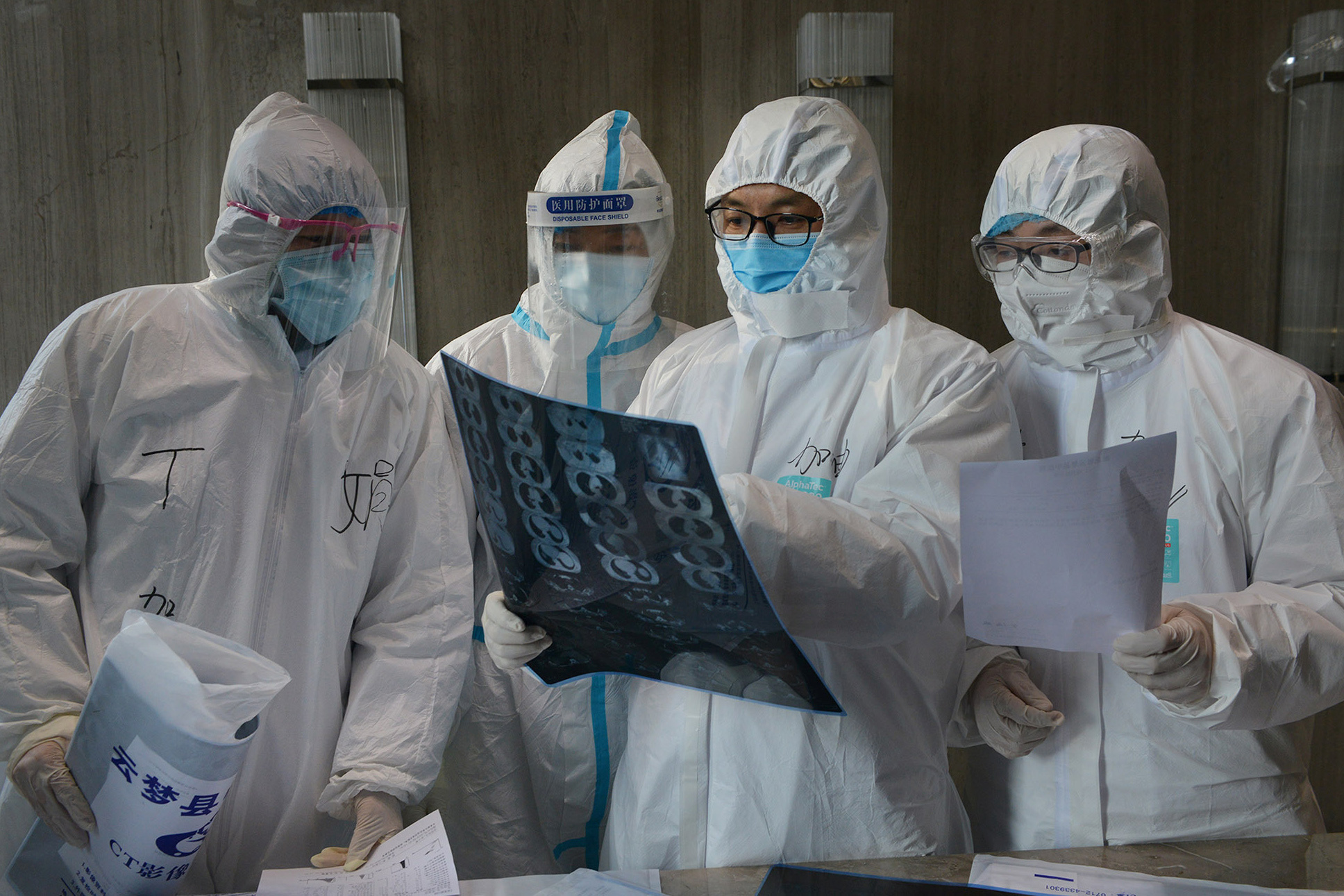 PHOTO: Medical workers in protective suits inspect a CT scan image at a hospital in Yunmeng county of Xiaogan city in Hubei, the province hit hardest by the novel coronavirus outbreak, China, Feb. 20, 2020.