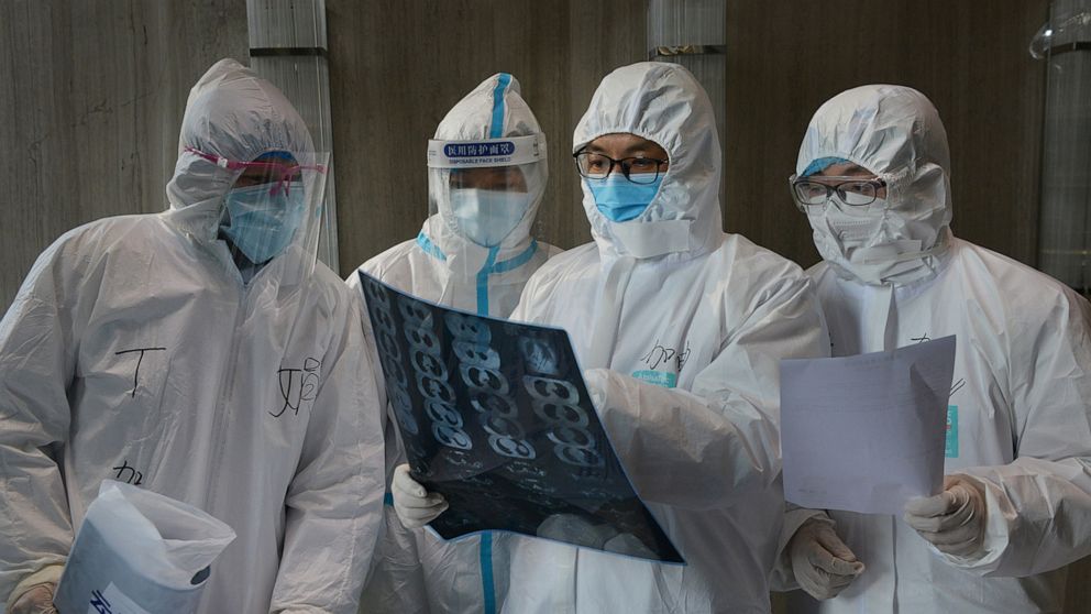 PHOTO: Medical workers in protective suits inspect a CT scan image at a hospital in Yunmeng county of Xiaogan city in Hubei, the province hit hardest by the novel coronavirus outbreak, China, Feb. 20, 2020.