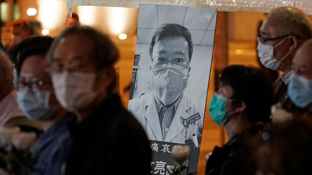 PHOTO: In this file photo taken on Feb. 7, 2020, people wearing masks attend a vigil for Chinese doctor Li Wenliang, who was reprimanded for warning about the outbreak of the novel coronavirus and later died from the disease, in Hong Kong.