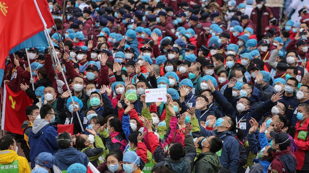 PHOTO: Medical staff celebrate after all patients were discharged at a temporary hospital set up to treat people with the novel coronavirus in Wuhan in China's central Hubei province on March 9, 2020. 