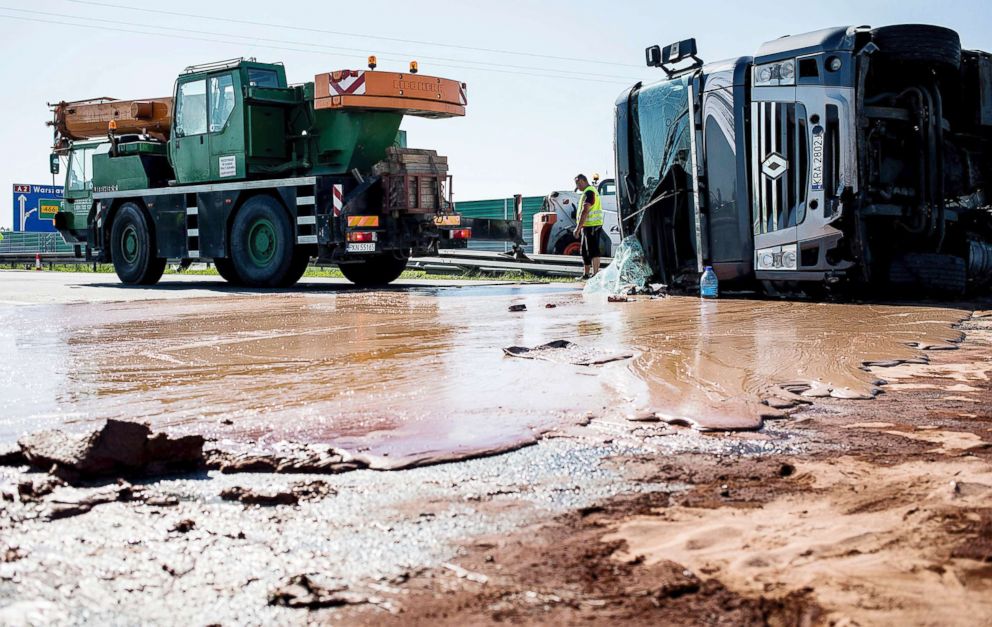 PHOTO: Tons of liquid milk chocolate is spilled on a highway after a truck transporting it overturned near Slupca, in western Poland, May 9, 2018.