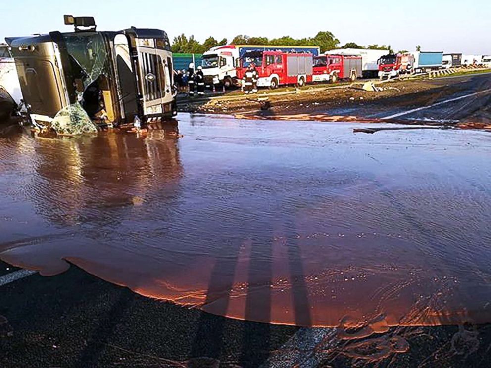 PHOTO: A tractor-trailer lies in liquid chocolate after overturning on a Polish highway in Poland, May 09, 2018.