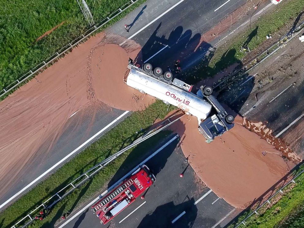 PHOTO: This video grab taken from Polish private TVN channel shows hot chocolate poured out over the A2 highway between Wrzesnia and Slupca near Poznan, western Poland, on May 9, 2018.
