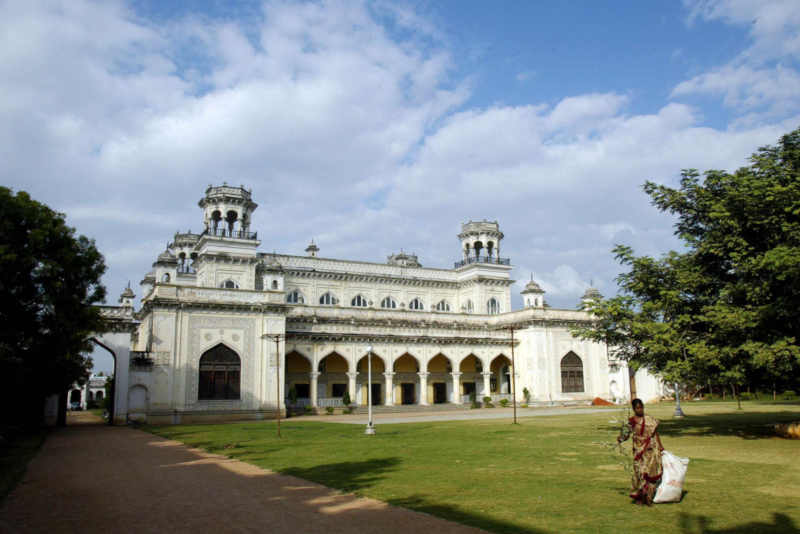 PHOTO: An Indian woman collects leaves fallen on the lawns of the Chowmahalla Palace in the old city of Hyderabad on Nov. 19, 2008.