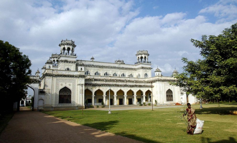 PHOTO: An Indian woman collects leaves fallen on the lawns of the Chowmahalla Palace in the old city of Hyderabad on Nov. 19, 2008.