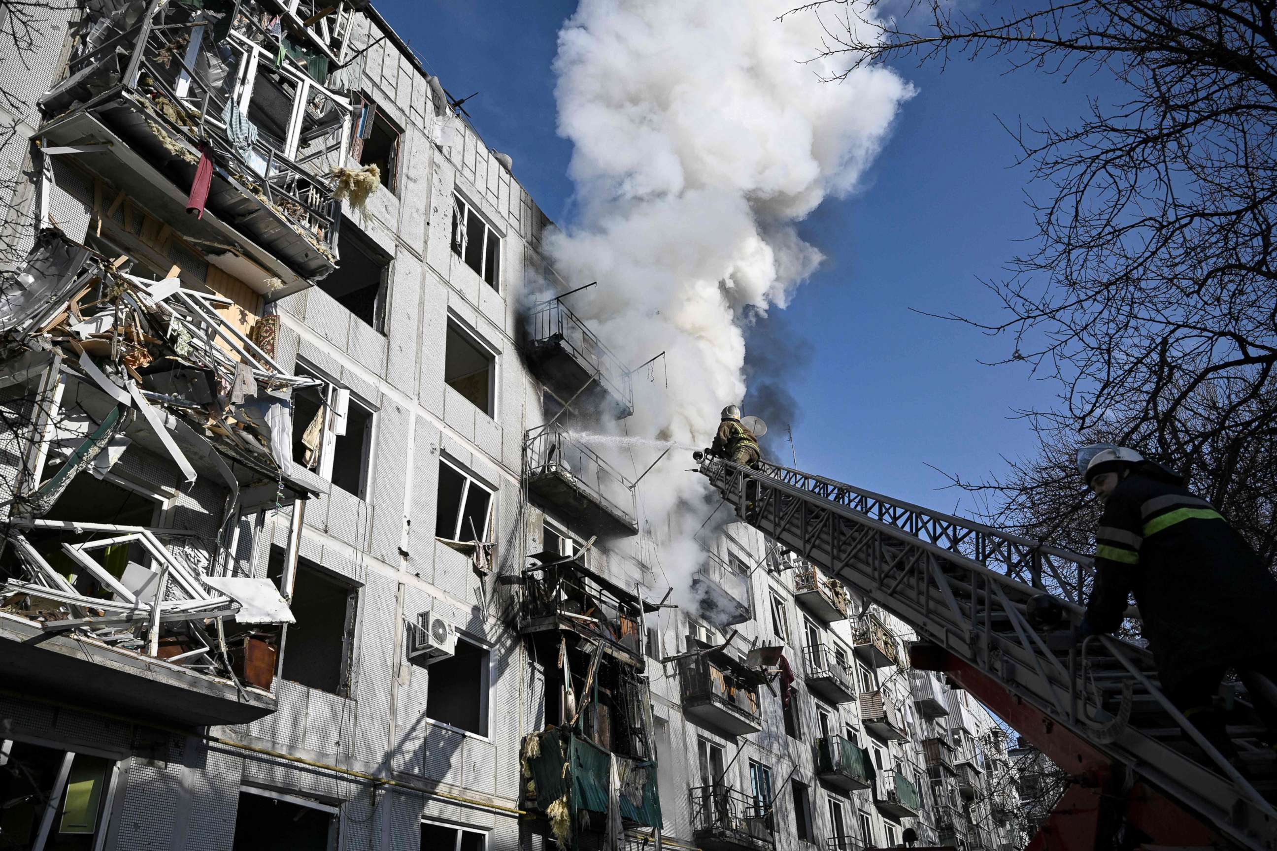 PHOTO: Firefighters attend to a fire in a building after bombings in the eastern Ukraine town of Chuguiv, eastern Ukraine 25 miles from Kharkiv on Feb. 24, 2022.