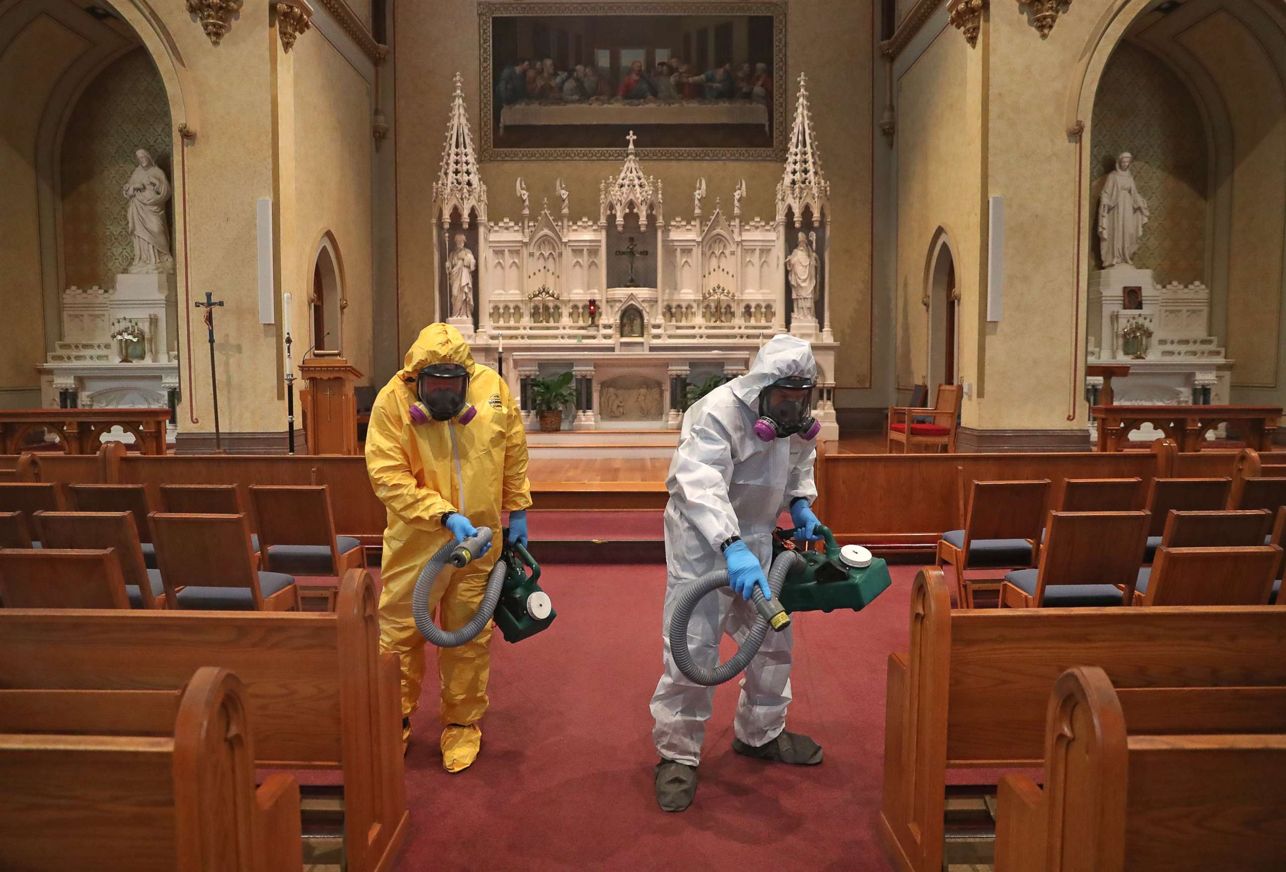 PHOTO: Mark Burgess, left, and David Rossini with Bostonian Cleaning and Restoration of Braintree cleans the aisle at St. Gregory's Church in Boston's Dorchester during the COVID-19 pandemic on May 18, 2020.