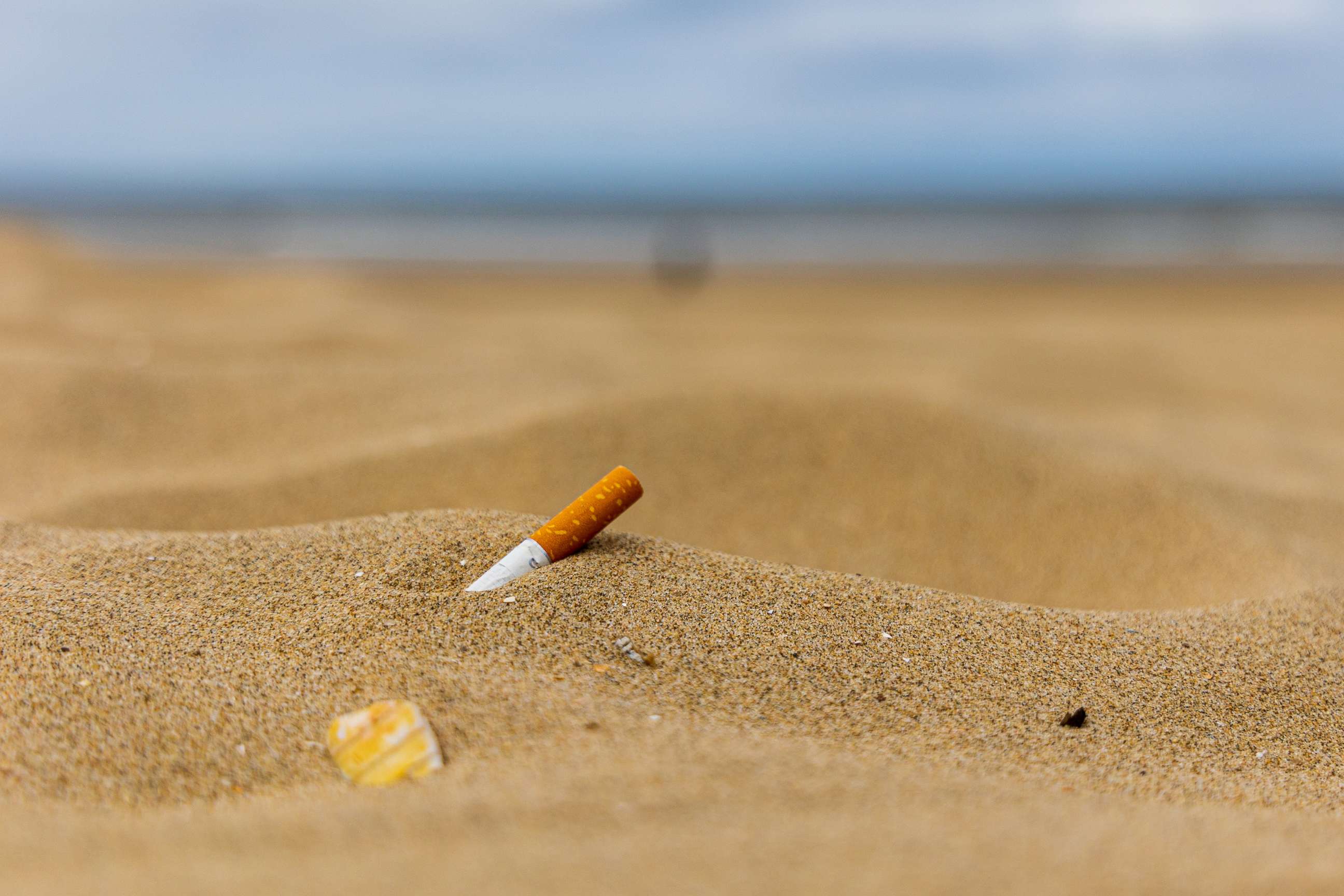 PHOTO: In this undated stock photo, a cigarette butt is shown in the sand on a beach.