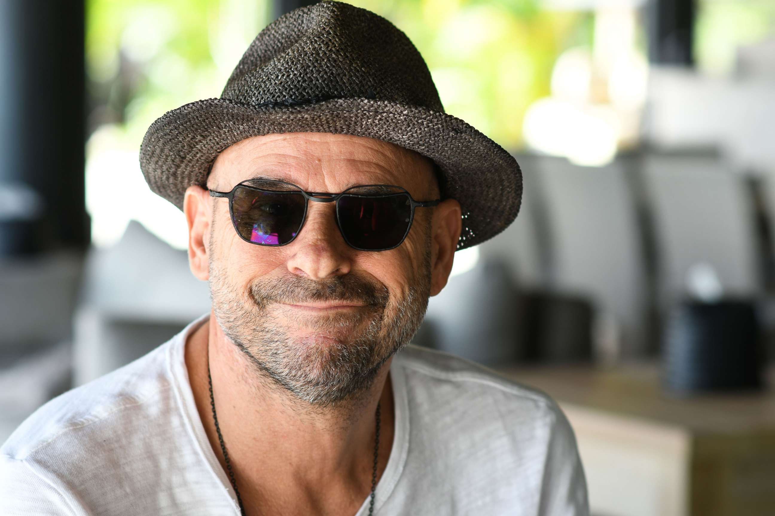 PHOTO: In this file photo taken on July 19, 2019, Guy Laliberte, co-founder of global circus company Cirque du Soleil, poses for a photo on his private island of Nuketepipi in French Polynesia.