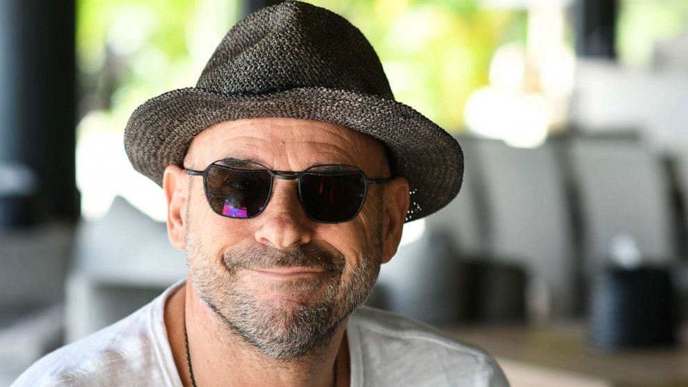 PHOTO: In this file photo taken on July 19, 2019, Guy Laliberte, co-founder of global circus company Cirque du Soleil, poses for a photo on his private island of Nuketepipi in French Polynesia.