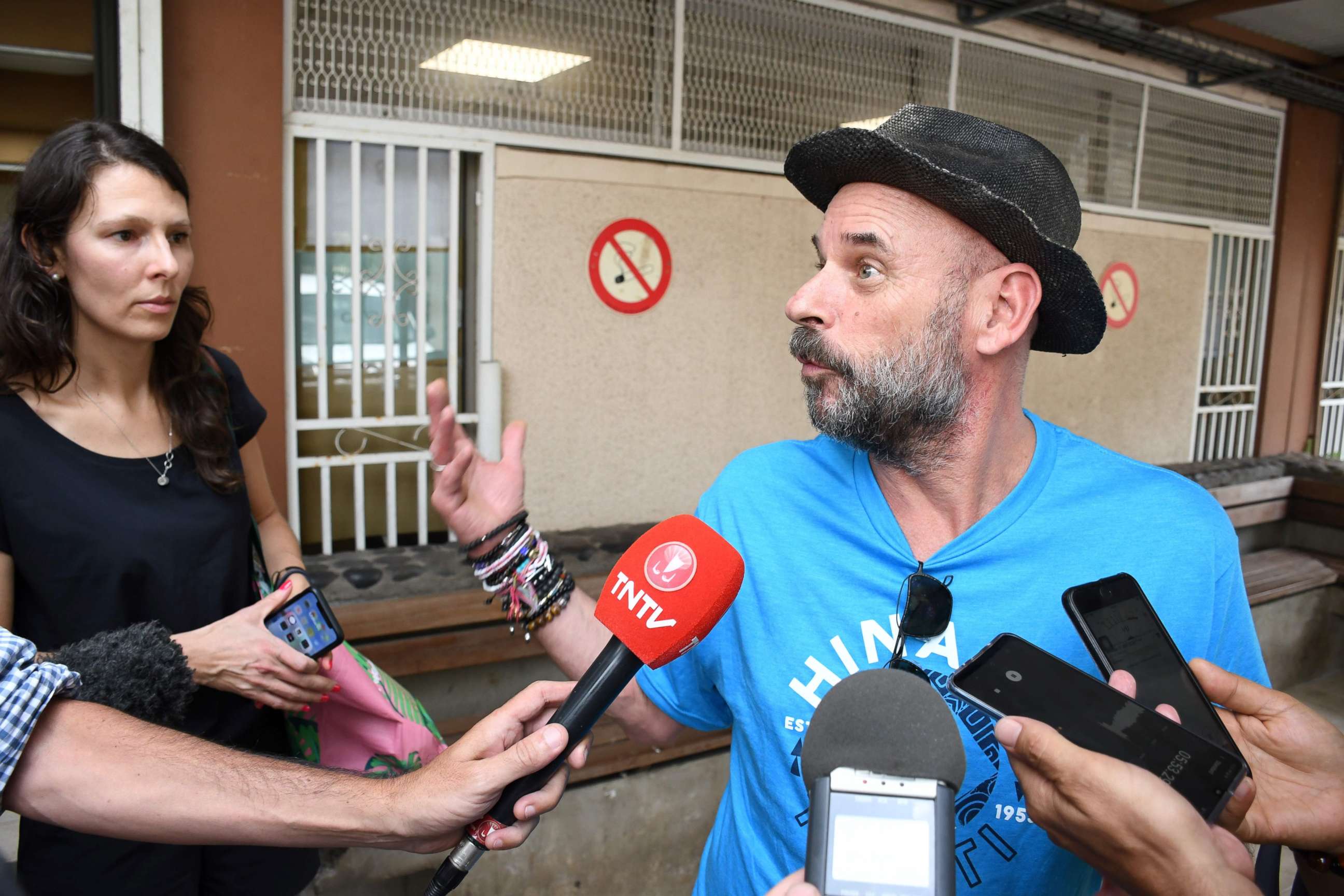 PHOTO: Guy Laliberte, billionaire co-founder of global circus company Cirque du Soleil, speaks to the press while Anne Dongois, communication director of Lune Rouge, listens on, as they leave the courthouse of Papeete, French Polynesia, on Nov. 13,  2019.