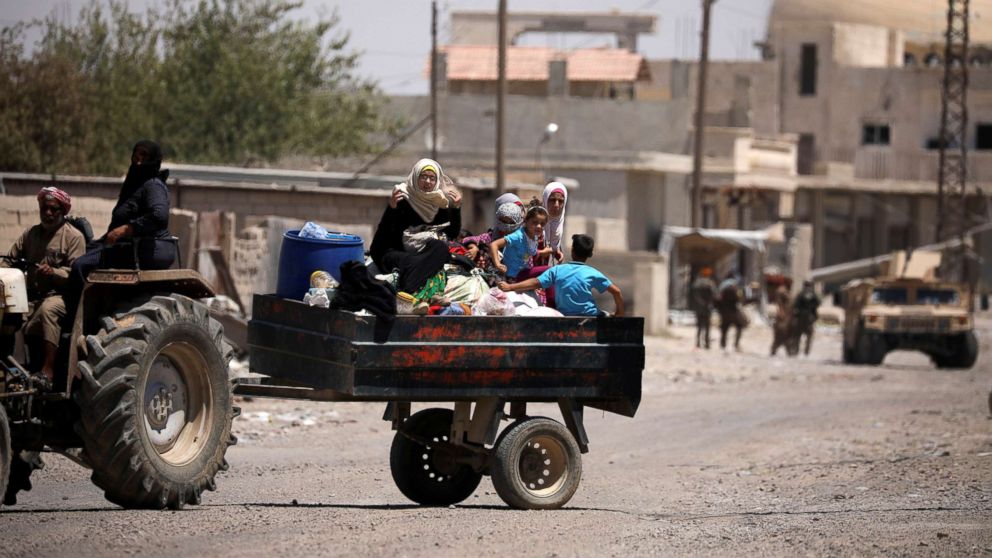 People are seen fleeing Raqqa, Syria, July 31, 2017. 