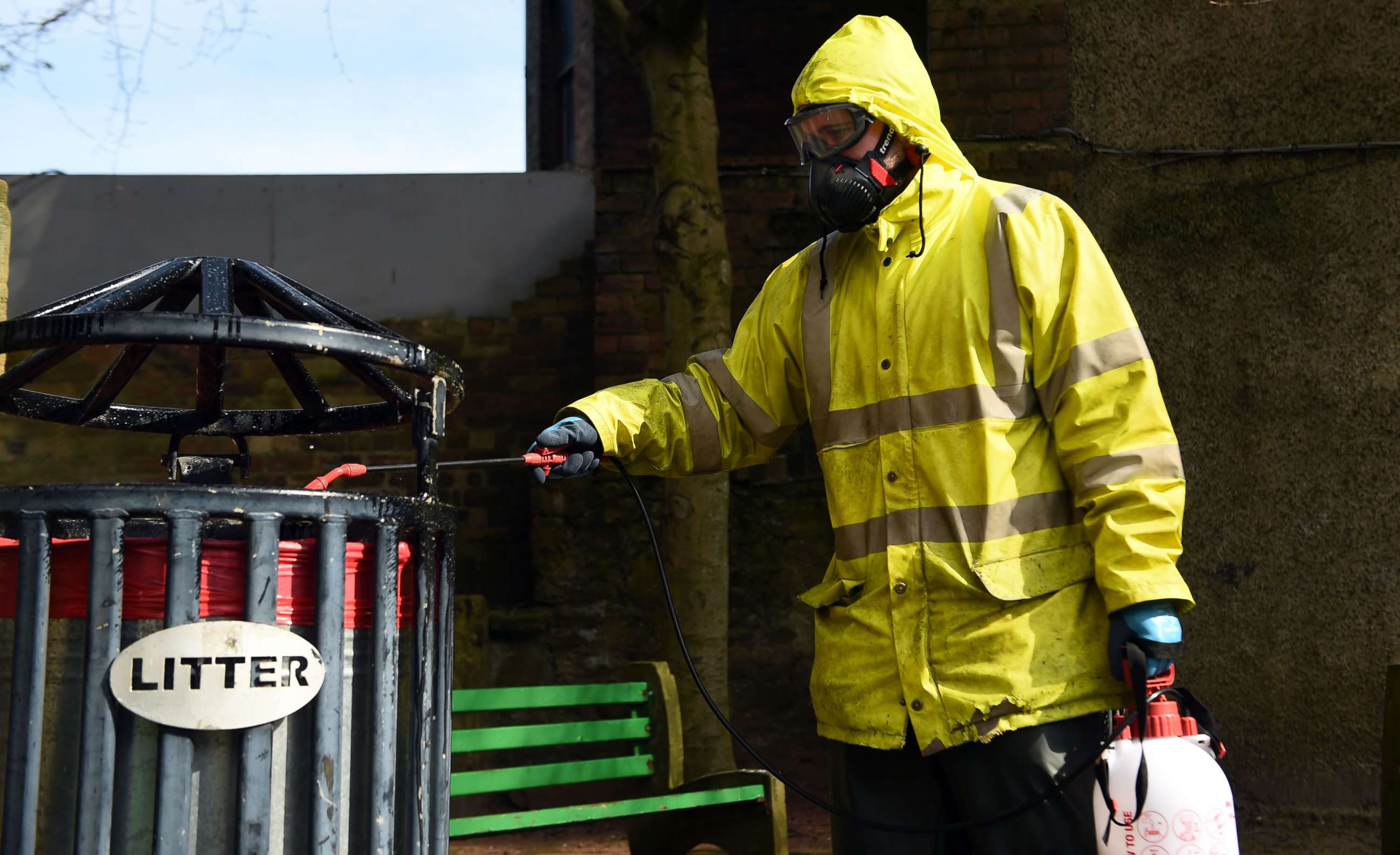 PHOTO: Exterior cleaning contractor Robin Barclay from Flamingo Exterior Cleaning voluntarily disinfects around a litter bin in a public space in Ayr town Centre on the west coast of Scotland on April 18, 2020.
