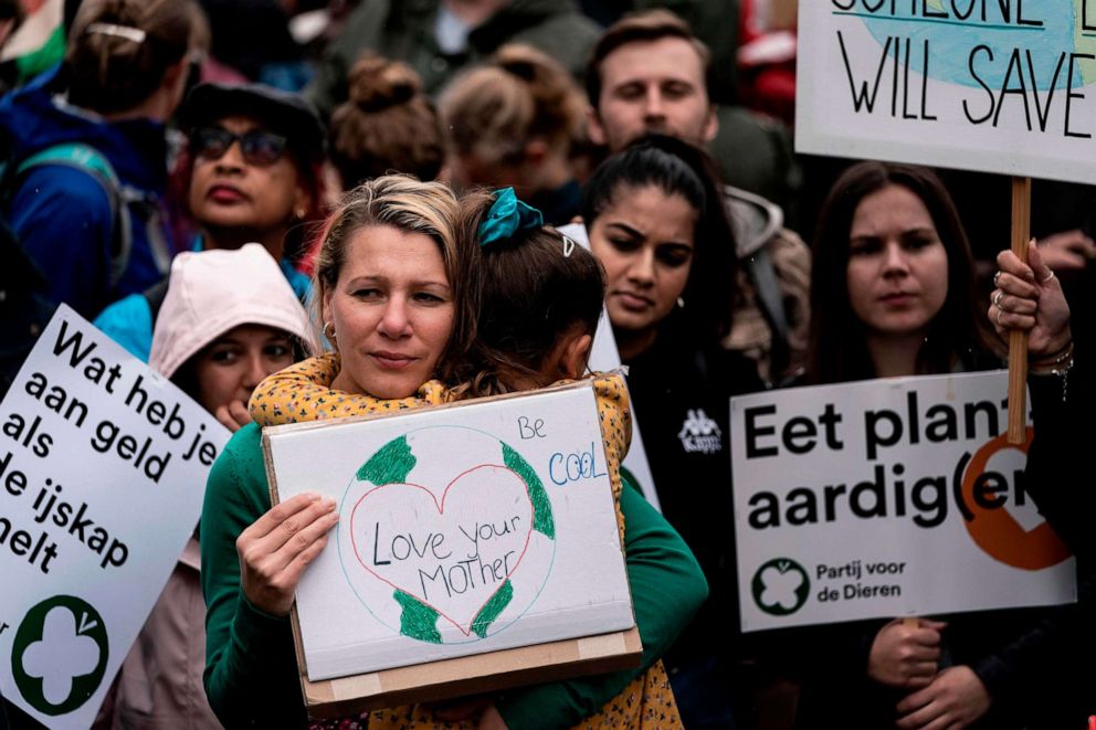 PHOTO: Protesters hold placards as they participate in the Global Climate Strike organised by the "Fridays For Future" at the end of the global climate change week in The Hague, the Netherlands, on September 27, 2019.