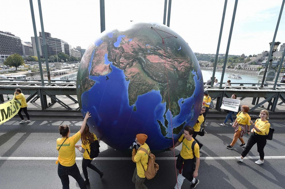 PHOTO: Protesters march with a globe balloon on the oldest Hungarian bridge, the 'Lanchid' (Chain Bridge) during the Global Climate Strike organized by the 'Fridays For Future Hungary' at the end of the global climate change week in Budapest.