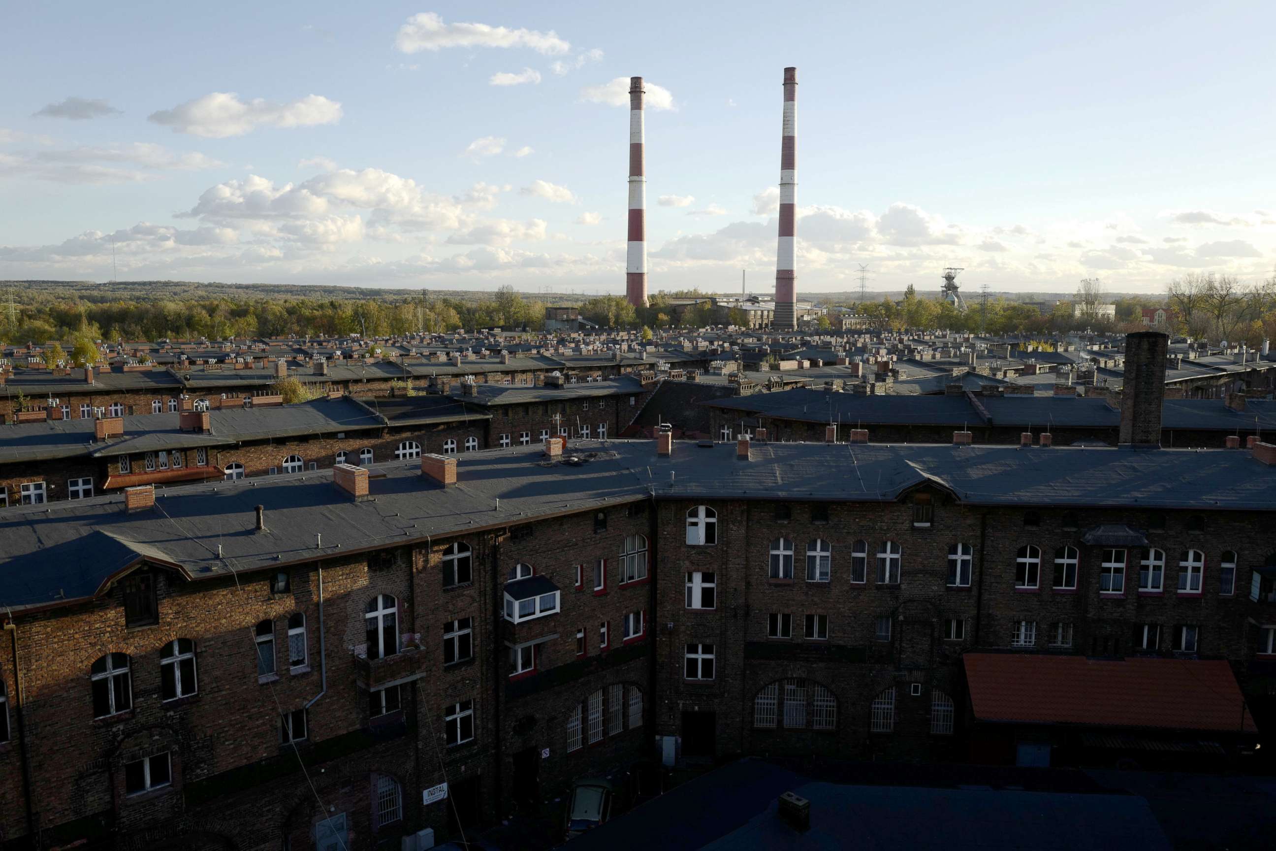 PHOTO: Houses and the Wieczorek mine power plant chimneys are seen in Nikiszowiec district in Katowice, Poland, Oct. 24, 2018.