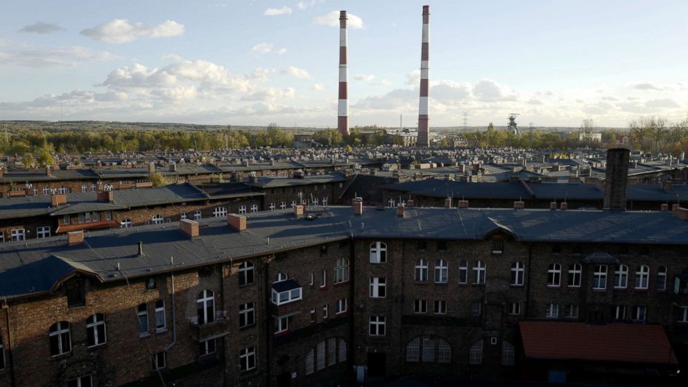 Houses and the Wieczorek mine power plant chimneys are seen in Nikiszowiec district in Katowice, Poland, Oct. 24, 2018.